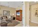 Cozy living room with a ceiling fan, comfortable sofa, and a wooden entertainment center at 1940 Scarlett Ave, North Port, FL 34289