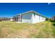 Backyard of house with screened patio and green lawns at 2241 Boxwood St, North Port, FL 34289