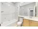 Bright bathroom with a shower-tub combo, neutral vanity, and beige tile flooring at 2241 Boxwood St, North Port, FL 34289