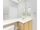 Bathroom featuring a large mirror, bright white countertop, and neutral-toned cabinetry at 2241 Boxwood St, North Port, FL 34289