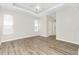 Inviting bedroom with wood floors, a tray ceiling, and ample natural light from large windows at 2241 Boxwood St, North Port, FL 34289
