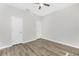 A neutral, gray-walled bedroom featuring modern wood-look floors and bright white doors and trim at 2241 Boxwood St, North Port, FL 34289