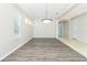 Dining Room boasting hardwood floors, natural light, and an elegant chandelier at 2241 Boxwood St, North Port, FL 34289