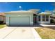 Charming single-story home featuring a well-manicured lawn and attached garage at 2241 Boxwood St, North Port, FL 34289