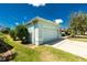 View of the two-car garage and beautifully landscaped yard at 2241 Boxwood St, North Port, FL 34289