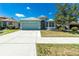 Landscaped front yard featuring a vibrant green lawn and tree at 2241 Boxwood St, North Port, FL 34289