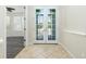 Inviting foyer with tiled floors and elegant French doors welcoming in natural light at 2241 Boxwood St, North Port, FL 34289