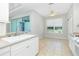 Eat-in kitchen featuring white cabinetry, tile floors and a view of the backyard at 2241 Boxwood St, North Port, FL 34289