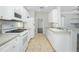 Eat-in kitchen with white cabinets, tile floors, stainless appliances, and breakfast bar at 2241 Boxwood St, North Port, FL 34289