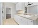 Bright kitchen featuring white cabinetry, tile floors and stainless steel appliances at 2241 Boxwood St, North Port, FL 34289