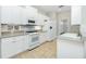 Bright kitchen with white cabinets, tile floors and stainless steel appliances and plenty of storage at 2241 Boxwood St, North Port, FL 34289