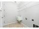Bright laundry room features tile floor, wire shelving, and utility sink at 2241 Boxwood St, North Port, FL 34289