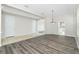 Open concept living room featuring a pendant light fixture and an archway to the kitchen at 2241 Boxwood St, North Port, FL 34289