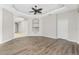 Open living room with hardwood floors, tray ceiling, and decorative built-ins for stylish storage at 2241 Boxwood St, North Port, FL 34289