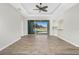 Spacious living room with hardwood floors, tray ceiling, and sliding doors leading to a screened pool at 2241 Boxwood St, North Port, FL 34289