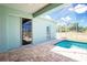 Covered brick patio and pool area with views of backyard at 2241 Boxwood St, North Port, FL 34289