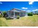 Screened-in pool with a covered patio and lush landscaping at 2241 Boxwood St, North Port, FL 34289