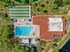 Aerial view showcasing the pool, shuffleboard courts, and outdoor amenities at 23465 Harborview Rd # 915, Punta Gorda, FL 33980