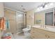 Bright bathroom with walk-in shower, updated vanity, and neutral tile at 23465 Harborview Rd # 915, Punta Gorda, FL 33980