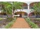 Beautiful walkway that leads to condo entrance, adorned with lush greenery and flowering plants at 23465 Harborview Rd # 915, Punta Gorda, FL 33980