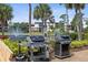 Outdoor grilling area with new grills, lake view, and lush landscaping at 23465 Harborview Rd # 915, Punta Gorda, FL 33980