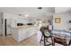 Spacious white kitchen with island, modern appliances, and tile flooring at 23465 Harborview Rd # 915, Punta Gorda, FL 33980