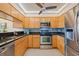 Updated kitchen features wooden cabinets, stainless steel appliances, granite countertops, and stylish backsplash at 23465 Harborview Rd # 915, Punta Gorda, FL 33980