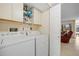 Functional laundry room featuring white appliances and ample storage at 23465 Harborview Rd # 915, Punta Gorda, FL 33980