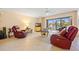 Bright and airy living room featuring tile floors, comfortable seating, and a slider that leads to a water view at 23465 Harborview Rd # 915, Punta Gorda, FL 33980