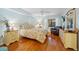 Bright main bedroom has hardwood floors, a ceiling fan, and a comfortable bed with coordinating furniture at 23465 Harborview Rd # 915, Punta Gorda, FL 33980