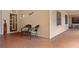 Comfortable condo patio featuring brick flooring, outdoor seating, and a 'Beach' sign on the wall at 23465 Harborview Rd # 915, Punta Gorda, FL 33980