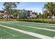 The community shuffleboard courts surrounded by benches, landscaping, and condos at 23465 Harborview Rd # 915, Punta Gorda, FL 33980