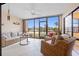 Relaxing sunroom featuring tile flooring, comfortable seating and scenic lake views from the surrounding windows at 23465 Harborview Rd # 915, Punta Gorda, FL 33980
