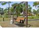 Inviting wooden swing set amongst lush tropical landscaping at community at 23465 Harborview Rd # 915, Punta Gorda, FL 33980