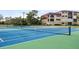 Close-up of the community tennis court, highlighting the net and court markings at 23465 Harborview Rd # 915, Punta Gorda, FL 33980