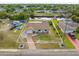 Aerial view showing the house, neighborhood, surrounding greenery, and canal at 2368 Pellam Blvd, Port Charlotte, FL 33948