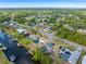 Wide angle aerial showcasing canal-front homes with docks and boat lifts, and lush, green landscaping surrounding the homes at 2368 Pellam Blvd, Port Charlotte, FL 33948