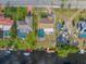 Aerial view of adjacent backyards featuring a screened in pool, patio, docks and boat lifts on a canal at 2368 Pellam Blvd, Port Charlotte, FL 33948