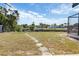 Expansive backyard with lush grass, a path, and a view of waterfront homes and a canal at 2368 Pellam Blvd, Port Charlotte, FL 33948