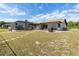Spacious backyard featuring an enclosed pool area, patio, and well-maintained lawn at 2368 Pellam Blvd, Port Charlotte, FL 33948