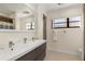 Bright bathroom featuring double sinks and a large mirror at 2368 Pellam Blvd, Port Charlotte, FL 33948