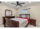 Well-lit bedroom with neutral tones, a wooden dresser, and a comfortable bed at 2368 Pellam Blvd, Port Charlotte, FL 33948