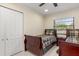 Cozy bedroom featuring twin beds with wooden frames and natural light from the window at 2368 Pellam Blvd, Port Charlotte, FL 33948