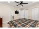 Bright bedroom featuring a ceiling fan, TV, and multiple closets for ample storage at 2368 Pellam Blvd, Port Charlotte, FL 33948
