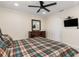 Bedroom with a ceiling fan, dresser, TV on the wall, and view of the doorway at 2368 Pellam Blvd, Port Charlotte, FL 33948