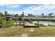 View of the wooden dock and canal, offering easy access for boating and enjoying waterfront activities at 2368 Pellam Blvd, Port Charlotte, FL 33948