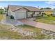 Charming single-story home featuring an attached garage, long driveway and minimal landscaping at 2368 Pellam Blvd, Port Charlotte, FL 33948