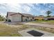 Single story home with a one car garage and a simple landscape design at 2368 Pellam Blvd, Port Charlotte, FL 33948