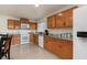Well-equipped kitchen featuring oak cabinetry, granite countertops, modern appliances, and a window at 2368 Pellam Blvd, Port Charlotte, FL 33948