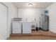 Functional laundry room with washer, dryer, utility sink, and water heater for convenience at 2368 Pellam Blvd, Port Charlotte, FL 33948